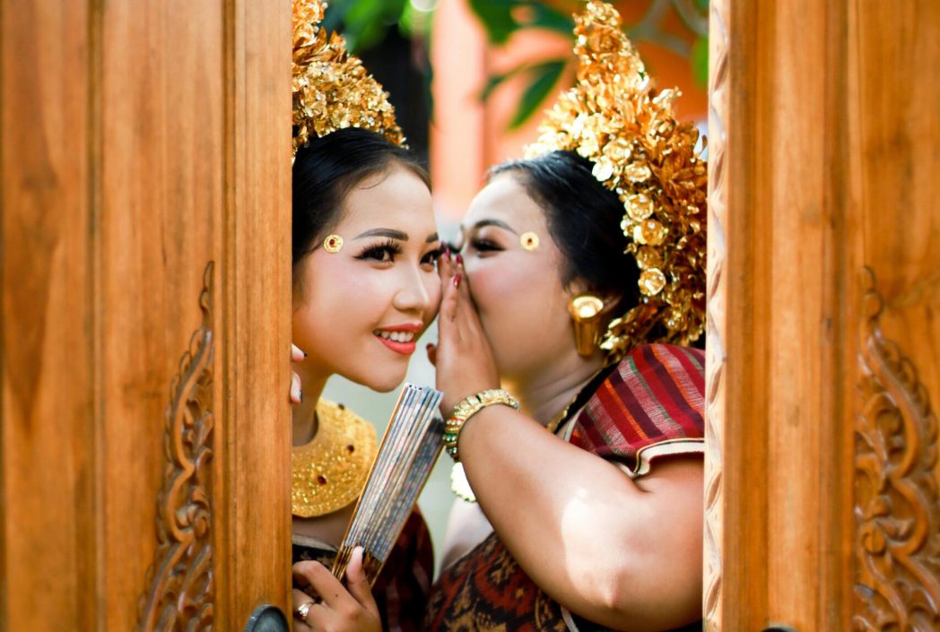 Woman in Red and Brown Dress Holding Brown Wooden Door Thailand Women